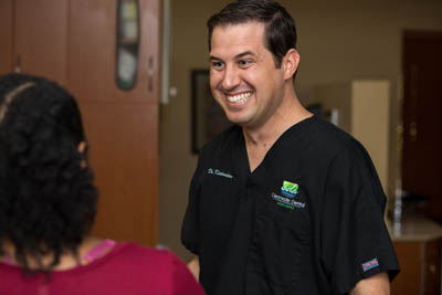 Dr. Keith M. Kiskaddon talking with a patient about all-on-4 dental implants