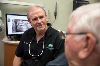 Dr. Nolan W. Allen discussing a patient's dental health