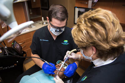 Clearwater Dental Associates dentists performing an oral surgery procedure on a patient