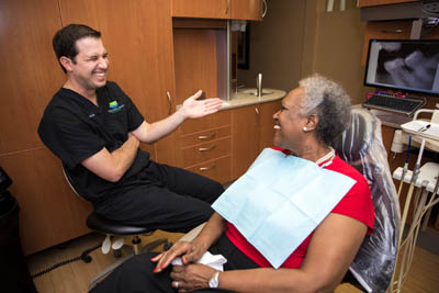 Dr. Keith M. Kiskaddon laughing with a dental patient