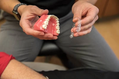 dentist showing how Invisalign clear aligners work