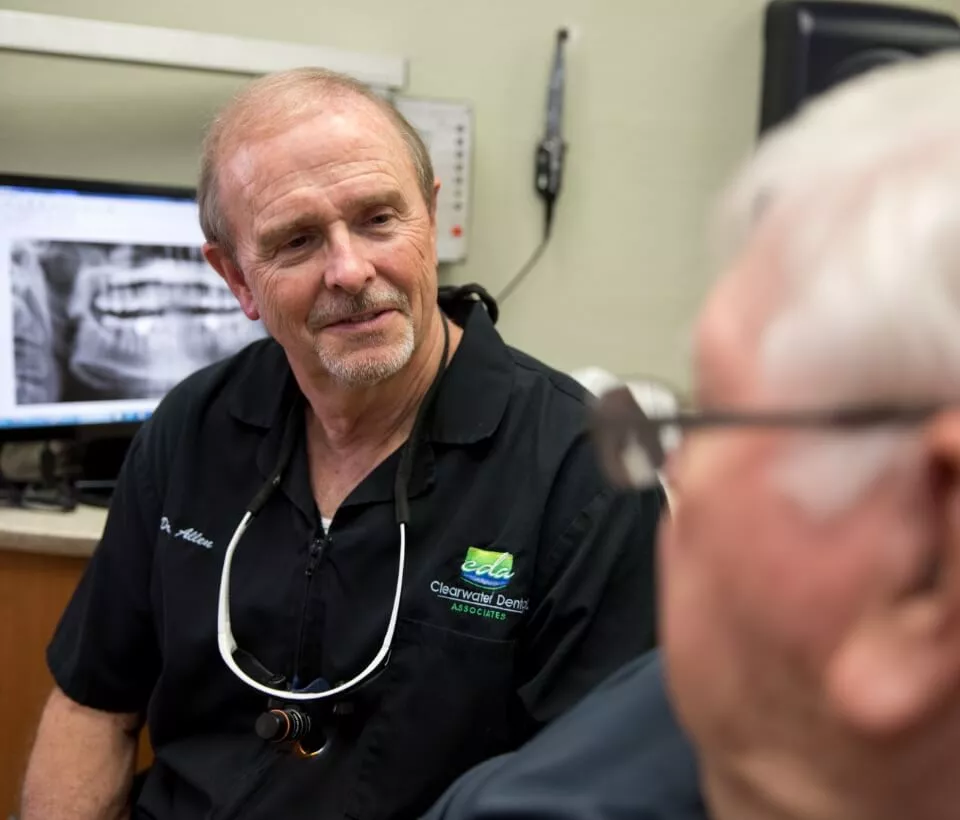 Clearwater dentist Dr. Nolan W. Allen discussing a patient's x-ray with him